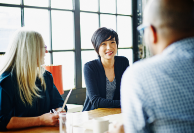 A woman smiling in a group interview
