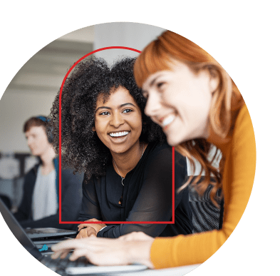 Close-up of two smiling women working together in an office