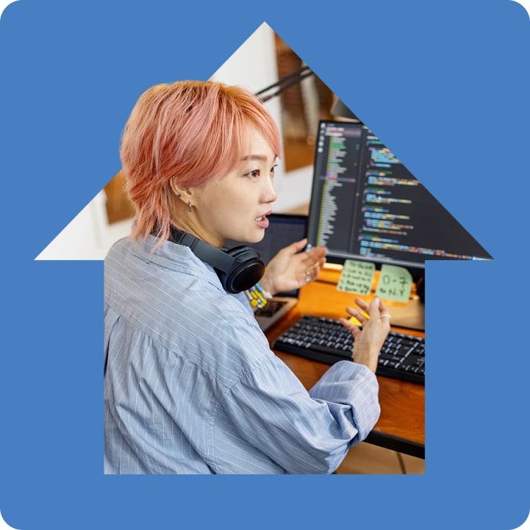 Asian woman sitting in front of a computer sharing thoughts with an unseen colleague