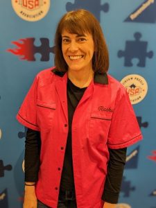Image of a smiling woman in front of a puzzle banner